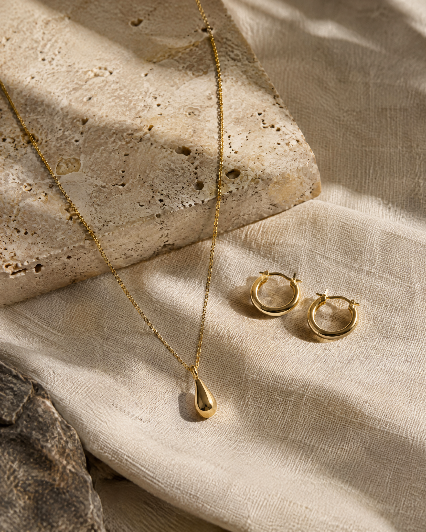Gold rings arranged on warm stone